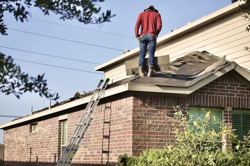 Professional roofer working on a residential roof in Rappahannock Academy